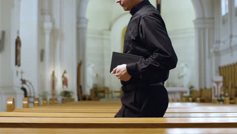 priest standing up from the bench