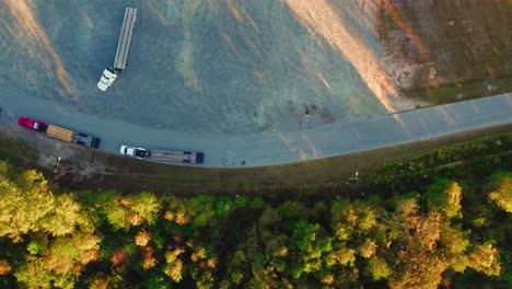 top down aerial hotshot type transportation, white pickup truck pulling gooseneck trailer flatbed