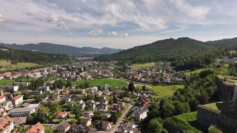 expansive aerial view of aarburg town, castle, and lush hills in the canton of solothurn, switzerland, with the aare river winding through a charming mix of historic and modern architecture