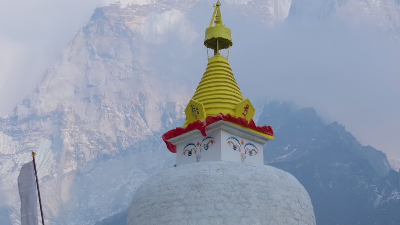 Aerial view of Dingboche Stupa at 4400m, Everest Base Camp trek. Gentle wind flows flag, serene stillness, holy site of Buddhist strength in Himalayas of Nepal