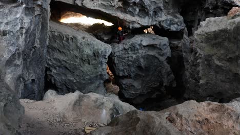 rock climber climbing cave rock interior, asian karst mountain caves