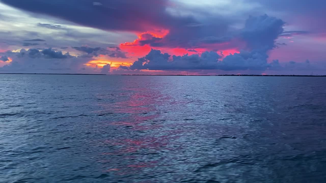Amazing crimson and orange colors of the horizon and clouds over the ocean in the Florida Keys, USA
