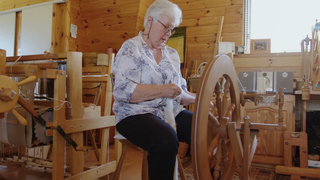 mujer mayor que opera una máquina de tejer 4k 4k