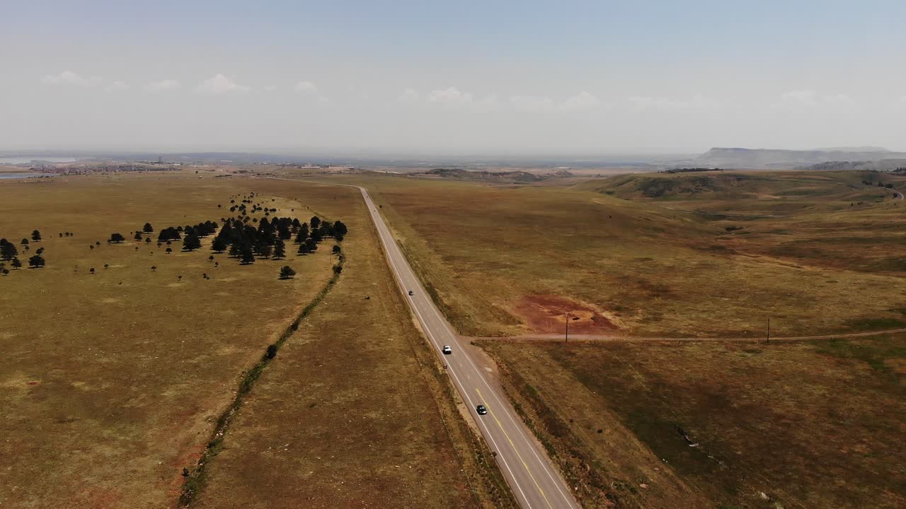A drone shot high over an open road, Golden Co.