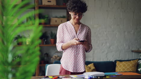 woman working from home using smartphone