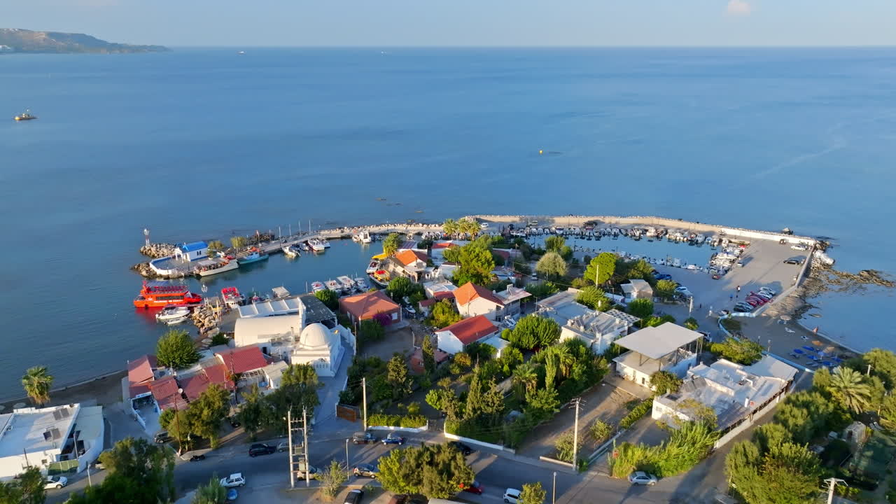 Aerial view backwards over the Faliraki harbor, golden hour in Rhodes, Greece