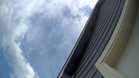 suburban home unique angle with time lapse clouds