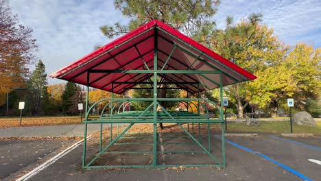 A-bicycle-stand-with-a-rain-cover-in-a-parking-lot