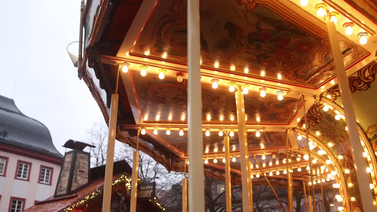 traditional lights spinning on an old german carousel in heidelberg at a Festive Christmas market in Europe