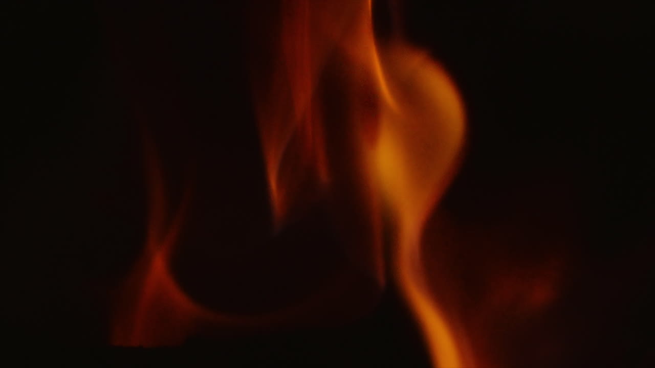 Log Burning with Bright Hot Burning Fire Flames Isolated on Black Background. Smooth Flowing Abstract Motion. Beautiful Twisting Flickering Glow