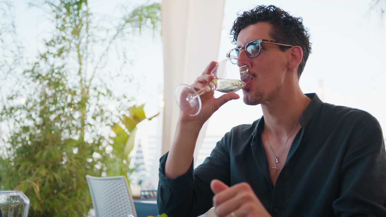 Man Cheering And Drinking With His Friend During Beach Resort Lunch