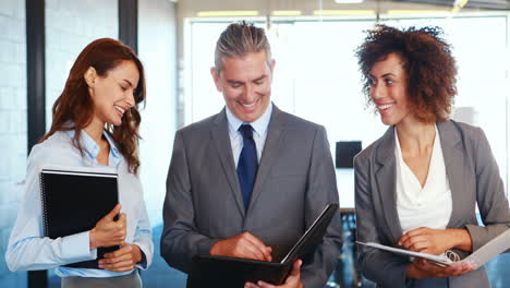 Business-team-standing-together-discussing-work