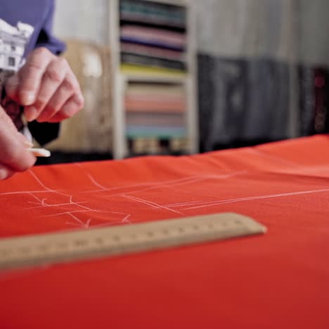 seamstress making pattern on fabric