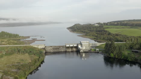 an aerial view of lairg dam on a misty morning