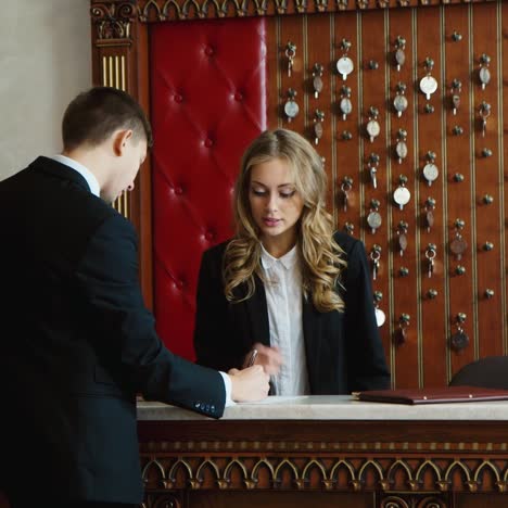 a group of businessmen fills out check in documents