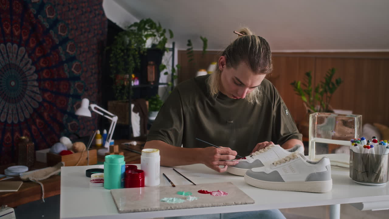 Fashion Stylist Drawing on Sneakers at Atelier