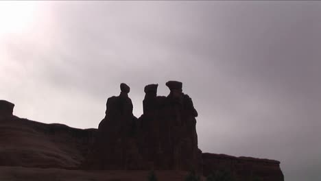 People-climb-across-a-rock-formation