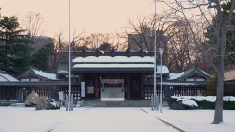 japanese shinto shrine at golden hour in winter, slow motion