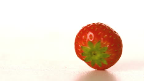 strawberry spinning on white surface