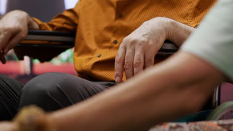 senior woman comforting her husband with impairment in wheelchair