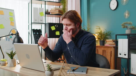 displeased sad businessman using laptop loss game fail computer virus error bad news at home office