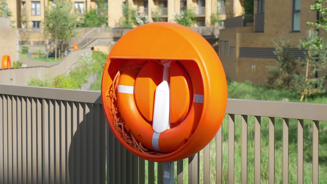 Lifebuoy near the lake in the city in 4k slow motion 60fps