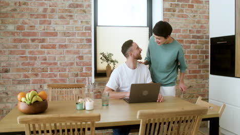 Man working on laptop on dining room