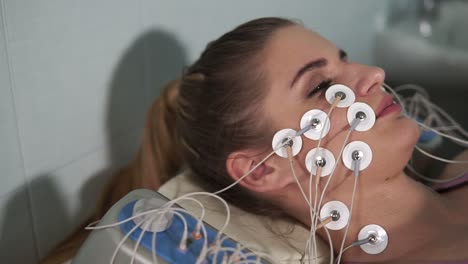 woman undergoing facial treatment with microcurrent therapy