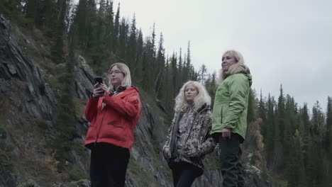 women and girls hiking in a mountainous forest