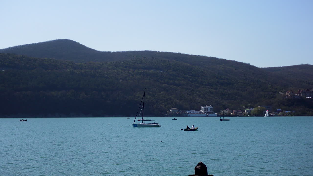 Scenic Lake View with Sailboats and Boats