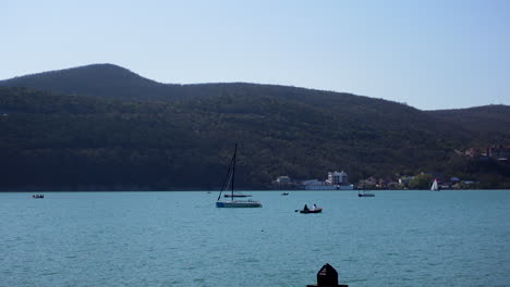 scenic lake view with sailboats and boats