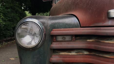 a close up shot of the headlight on an old, rundown car