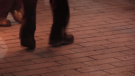 close up of 2 people skipping a fire rope on the streets slow motion