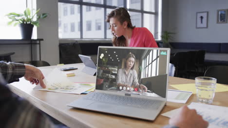 Caucasian-businessman-on-laptop-video-call-with-caucasian-female-colleague-on-screen