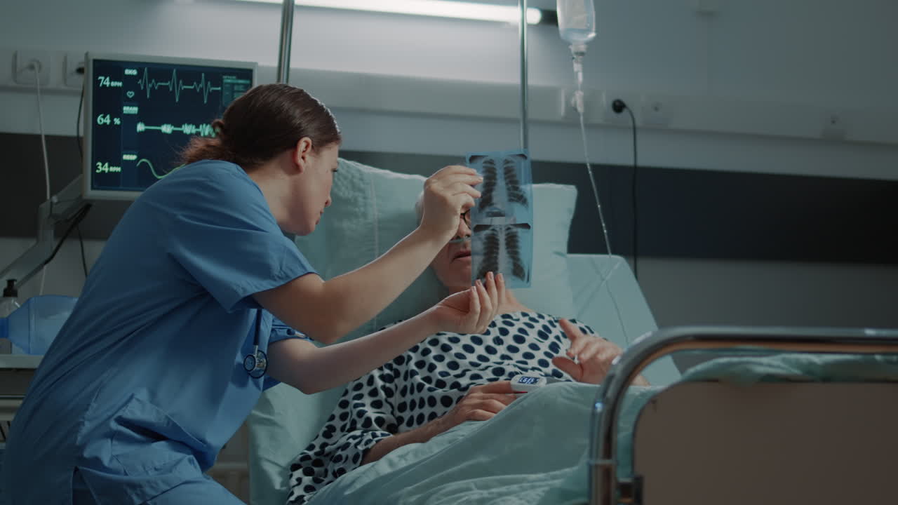 Sick elder man receiving xray test results in hospital ward