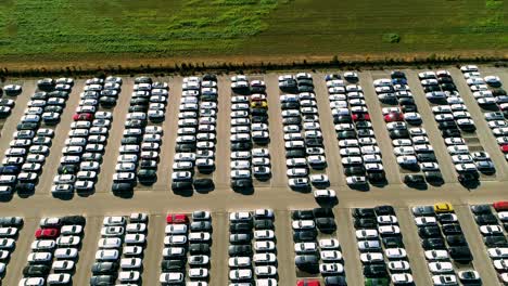 Aerial-footage-of-finished-cars-ready-to-be-shipped-on-huge-distribution-center