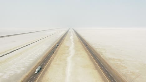 Vehicles-Travelling-On-The-White-Landscape-And-Unique-Salt-Flat-Of-Bonneville-In-Utah