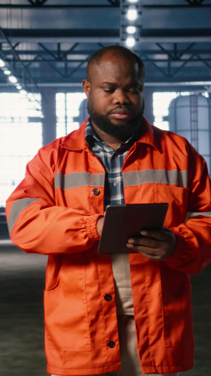 Vertical Video Specialist guiding colleague personnel with equipment as heavy machinery