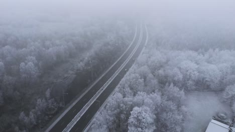 sweden landscape - aerial view of foggy weather over interstate road in the wintertime