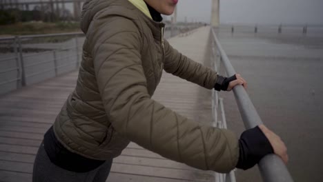 Joyful-hindu-woman-training-at-seaside-during-overcast-weather