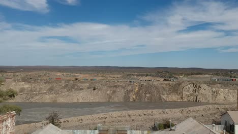 An-old-open-cut-mine-behind-an-abandoned-building-that-was-previously-a-mine-office