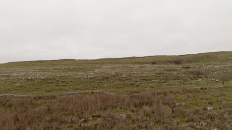 Aerial-descent-reveals-Burren-limestone-peak.-Ireland