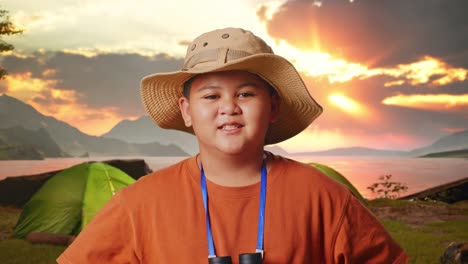 boy camping at sunset