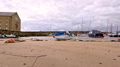 boats resting on sandy beach in scotland