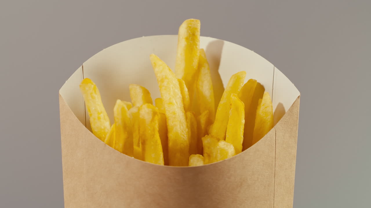 Läcker krispig pommes frites i en pappersbehållare