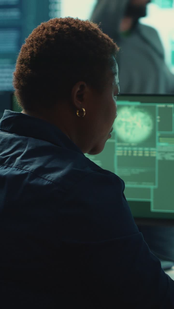 African American Woman Coding on Multiple Computer Screens