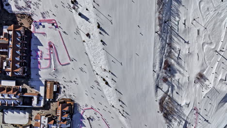 park city utah aerial v60 overhead view across ski slopes capturing winter vacation lodges and motions of cableway lifts and freestyle skiing and snowboarding - shot with mavic 3 cine - february 2022