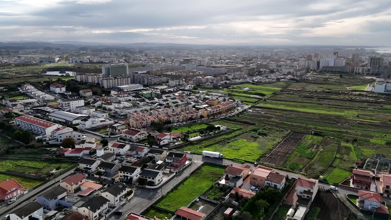 Aerial - smooth drone rotation of village and cultivated fields in Póvoa de Varzim, Portugal