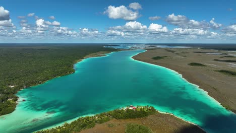 aerial view overlooking a exotic resort at the lagoon of seven colors, in sunny mexico - circling, drone shot