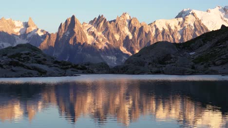 very colorful sunset on monte bianco mountain range and lake lac blanc in the france alps of europe